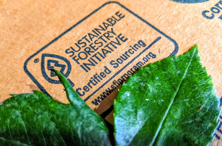 Sustainable Forestry Initiative logo on box bordered by leaves.